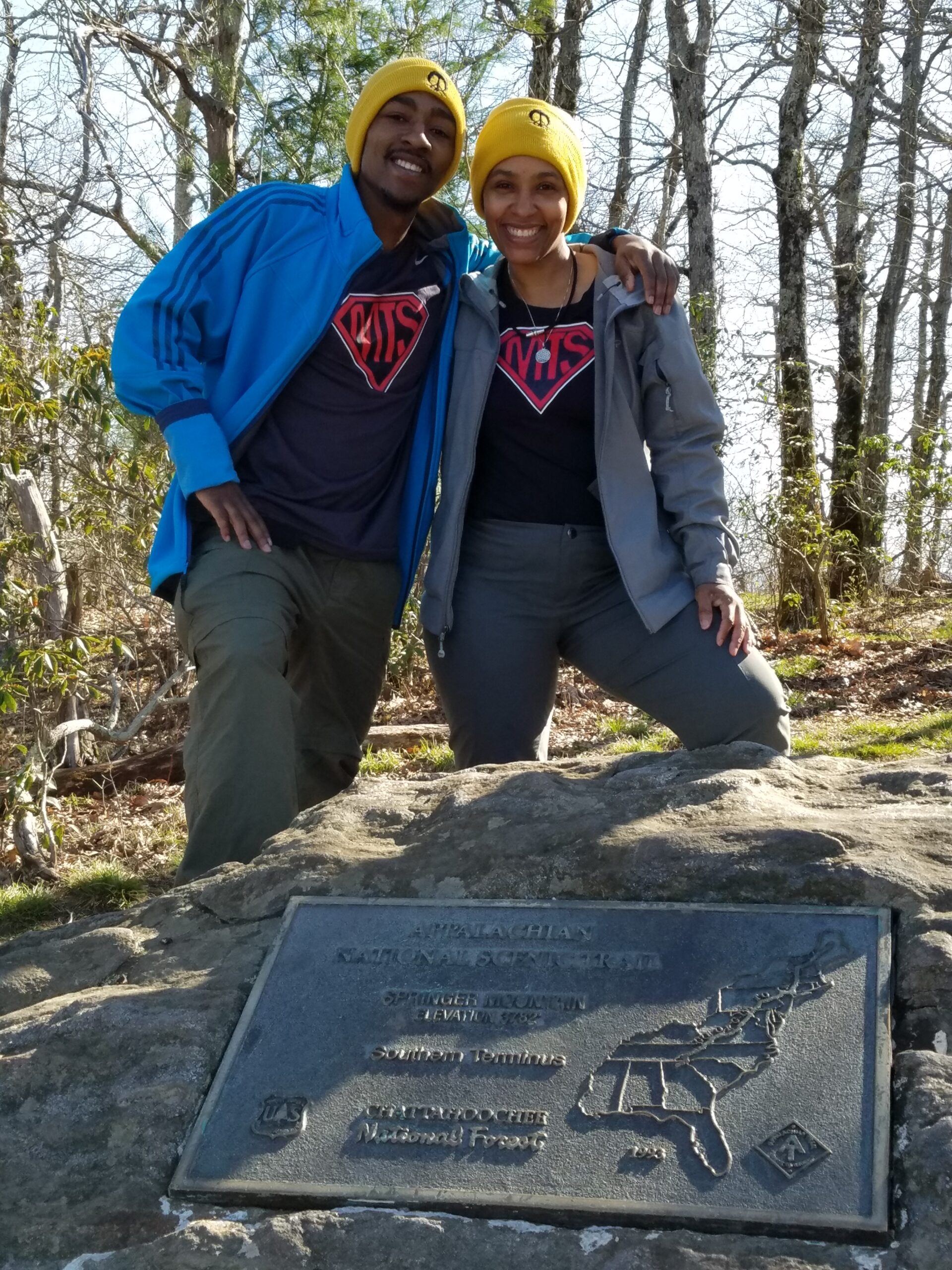 Kimberlee and her son standing together at Springer Mountain, plaque at the southern terminus of the Appalachian Trail in Georgia.